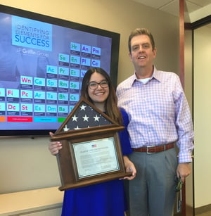 Photo of company president posing with employee celebrating her U.S. citizenship.