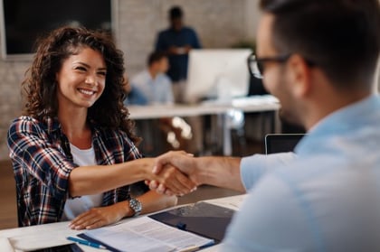 Female candidate shaking hands with an employer