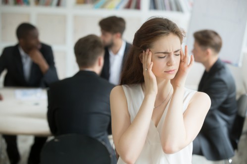 Stressed and ill female employee at work