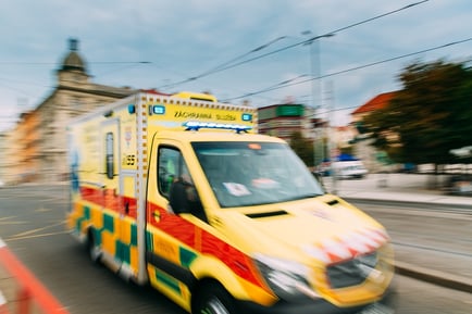 A photo of an ambulance racing through the streets of Europe.
