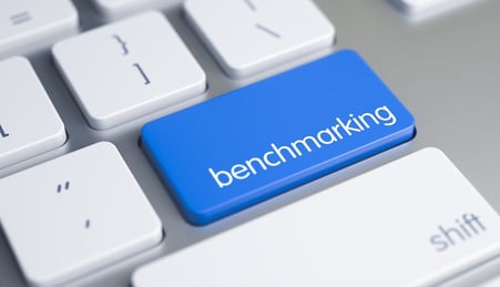 A close-up image of a computer keyboard with a key labeled "benchmarking" in focus.