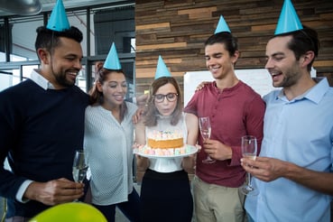 A photo of coworkers celebrating someone's birthday.