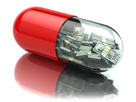 cartoon image of a pill capsule with money inside.