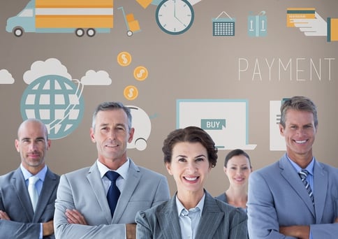 A photograph of businessmen and women with their arms crossed, smiling in front of business related graphics.