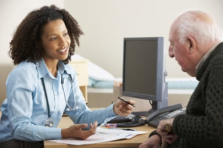 Doctor talking about Medicare and employee benefits with an elderly patient.