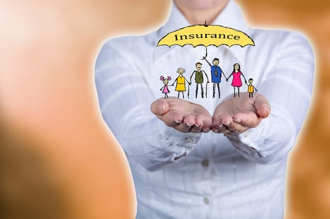 A photo of a woman holding a stick figure family under a life insurance umbrella in her hands.