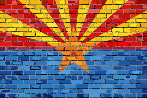 An image of the Arizona state flag painted on a brick surface.