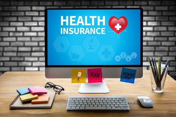 A photo of a desktop computer displaying a health insurance graphic.