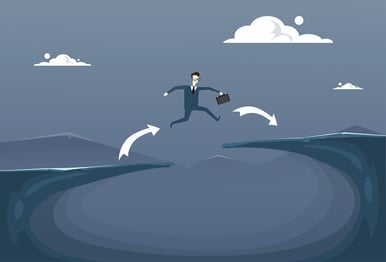 A cartoon image of a man wth a briefcase jumping over a gap.