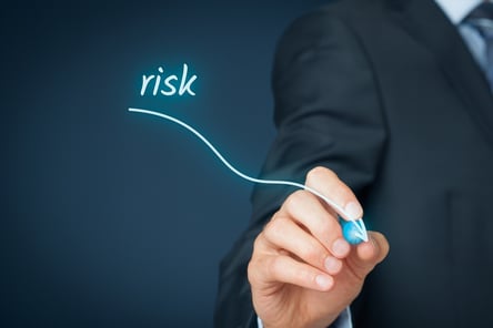 An image showing a person drawing a line sloping downward, indicating decreased risk with level funded health plans.