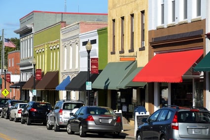 A photo of a row of awnings outside small businesses on a main street in a small town. 