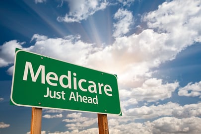 A green road sign indicating Medicare is just ahead.