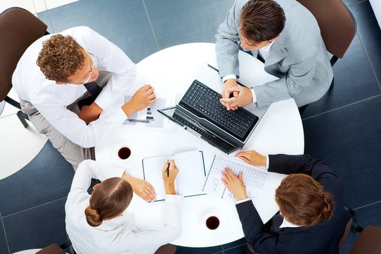 A photo of a group meeting with an employee benefits broker.